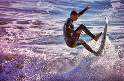 Woman jumping in sea