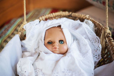 High angle view of doll in wicker basket