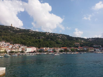 Scenic view of town against cloudy sky