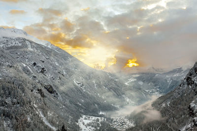 Scenic view of snowcapped mountains against sky during sunset