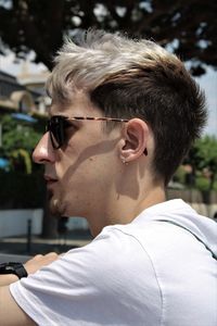 Portrait of young man looking away outdoors