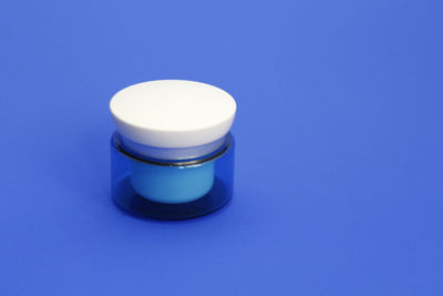 High angle view of tea light against blue background