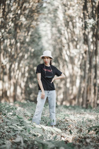 Full length portrait of man standing in forest