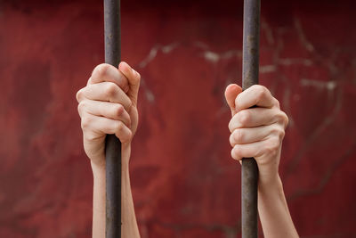 Close-up of human hand holding metal pole