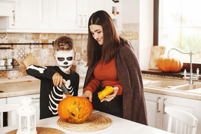 Full frame shot of pumpkin and woman at home