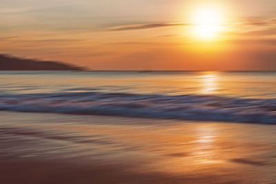 Scenic view of sea against romantic sky at sunset