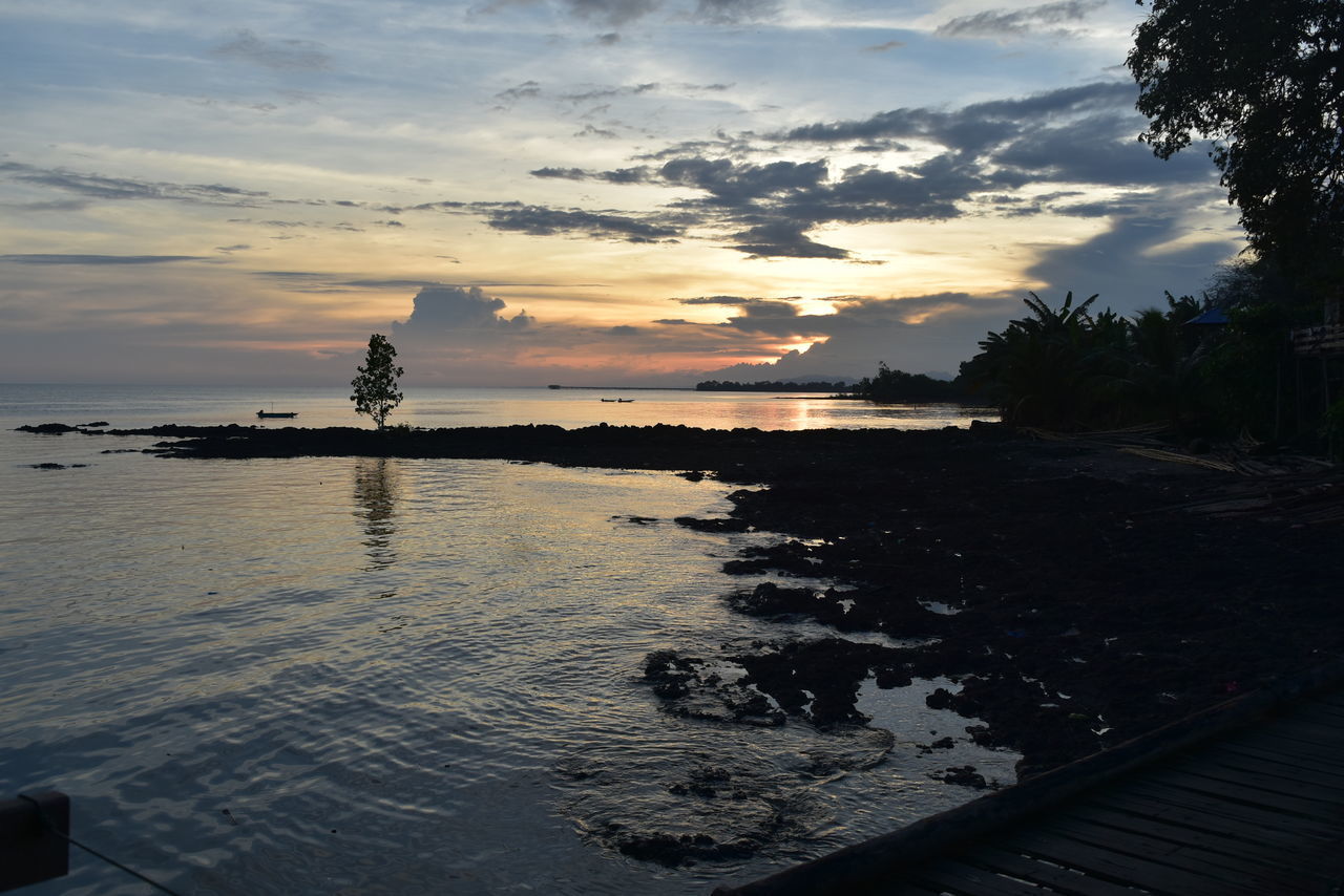 SCENIC VIEW OF SWIMMING POOL BY SEA AGAINST SKY DURING SUNSET