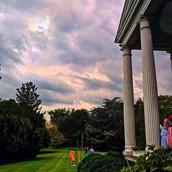 People in park against cloudy sky