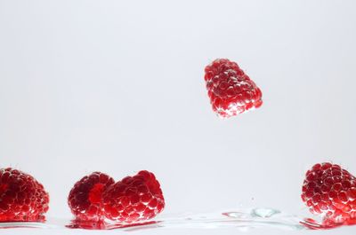 Close-up of strawberries on table against white background