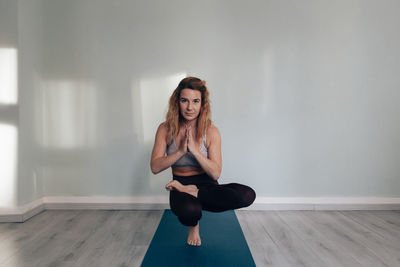 Yogic woman practicing in yoga studio