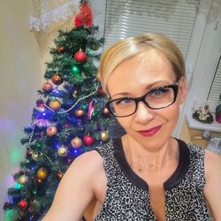 Portrait of smiling woman with christmas tree