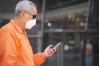 Young man using mobile phone in cafe