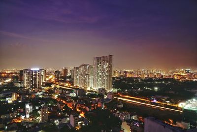 High angle view of illuminated buildings in city at night