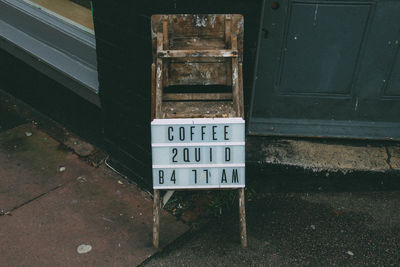 Close-up of sign board outside caf