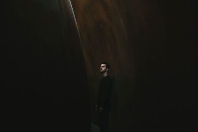 Woman standing against wall