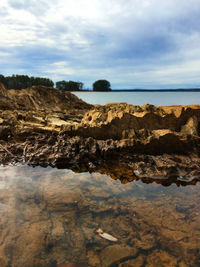 Rocks on beach against sky