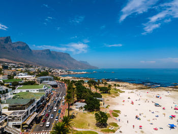 High angle view of townscape by sea against sky