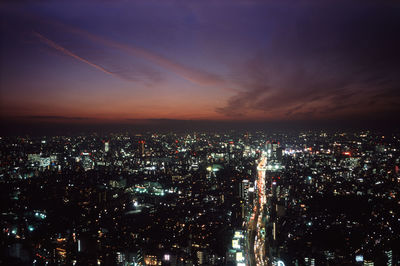 High angle shot of illuminated cityscape against sky