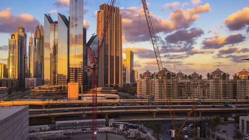 View of cityscape against cloudy sky