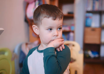 Cute young boy watching intently while bending his wrist