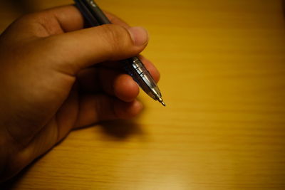 Close-up of person hand on table