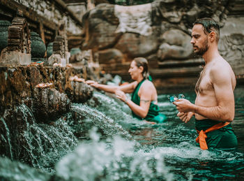 People sitting in water at park