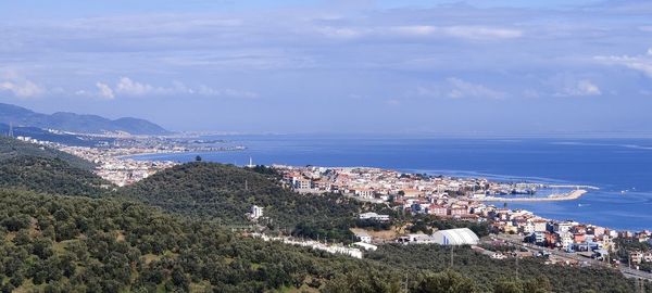 High angle view of townscape by sea against sky