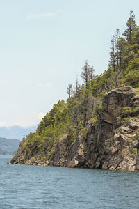 Scenic view of sea and mountains against sky