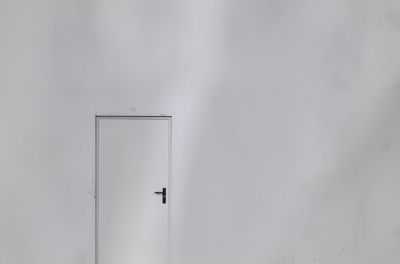 Close-up of closed door against white background