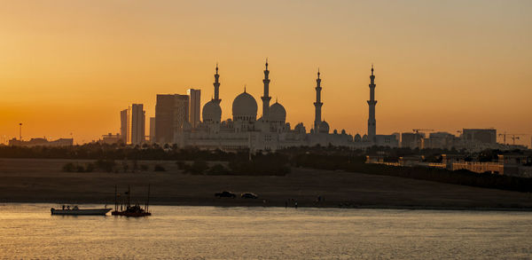 View of buildings in city at sunset