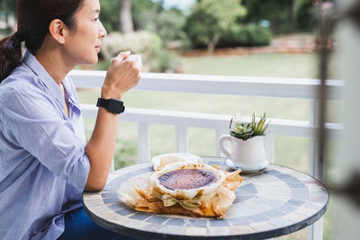 Midsection of woman with coffee