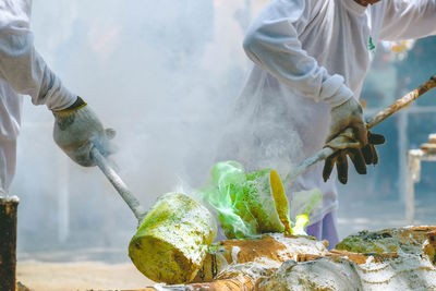 Midsection of man preparing food