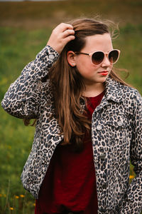 Young woman wearing sunglasses standing outdoors