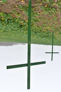 Cross on field against sky