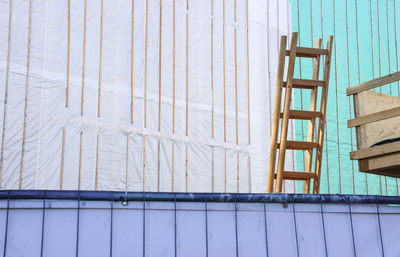 Low angle view of ladder against blue sky