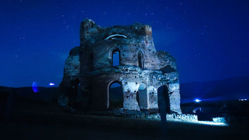 Low angle view of old building at night