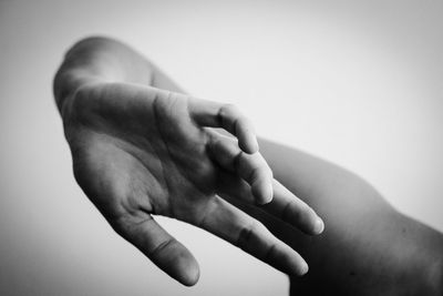 Close-up of hand holding over white background