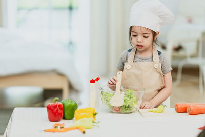 Midsection of woman eating food at home
