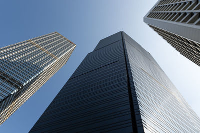 Low angle view of modern buildings against clear blue sky