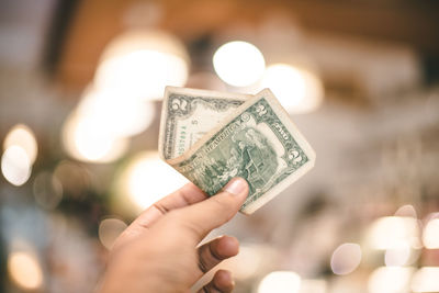 Close-up of hand holding candle