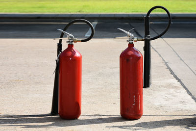 Close-up of red bell on sidewalk