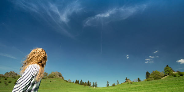 Woman on field against sky