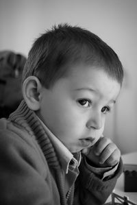 Portrait of cute boy looking away at home