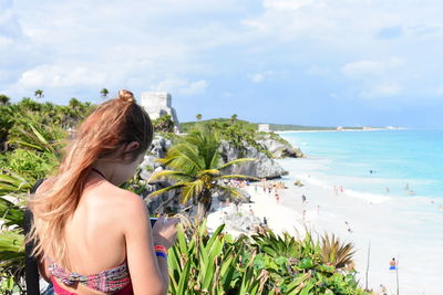 High angle view of woman standing against beach