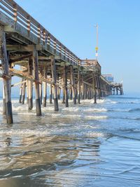 Pier over sea against clear sky