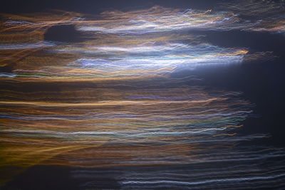 Full frame shot of illuminated rock in sea at night