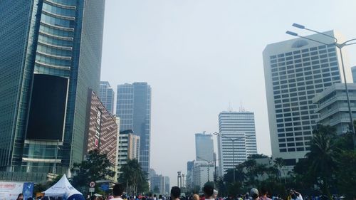 Buildings in city against clear sky