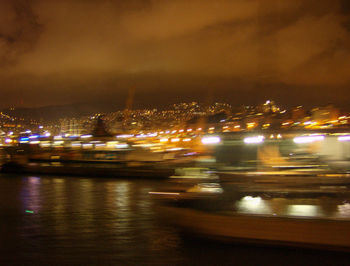 Illuminated city by road at night