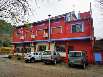 Cars on street against buildings in city