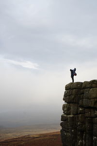 Man standing on mountain against sky